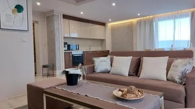 a living room with a couch and a table at PARADISO 'В' 607 Large Luxury Apartment in Nesebar