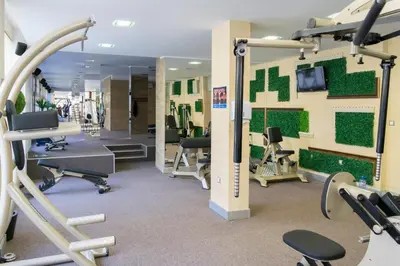 a gym with exercise equipment and a mirror at Harmony Suites Jungle - Family Friendly Complex in Sunny Beach