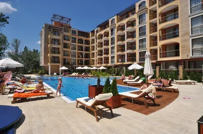 a group of people sitting around a pool at a hotel at Harmony Suites Jungle - Family Friendly Complex in Sunny Beach