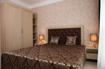 a bedroom with a large bed and two lamps at Harmony Suites Jungle - Family Friendly Complex in Sunny Beach