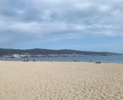a group of people on a beach near the water at Sunny apartment in Sunny Beach in Sunny Beach