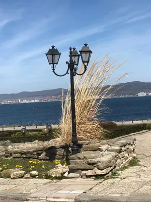 a street light sitting next to the water at Sunny apartment in Sunny Beach in Sunny Beach