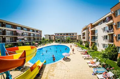 a resort with a pool with a boat on it at Waterpark Fort Apartments in Sunny Beach