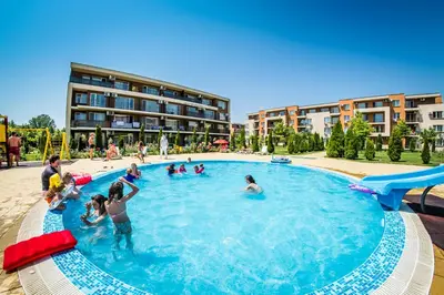 a group of people playing in a swimming pool at Waterpark Fort Apartments in Sunny Beach
