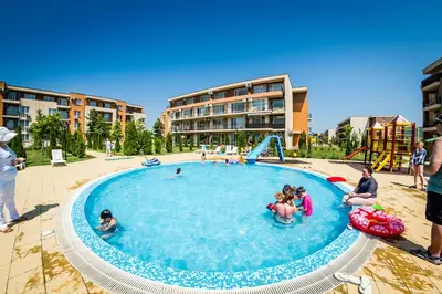 a group of people playing in a swimming pool at Waterpark Fort Apartments in Sunny Beach