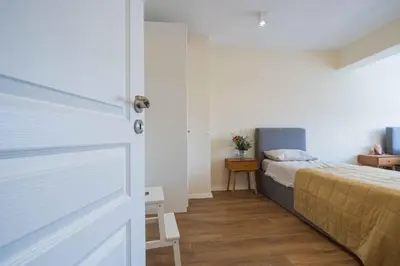 a bedroom with a bed and a door at Central DELUXE Apartment in Burgas City