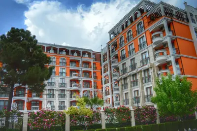an orange building with flowers in front of it at Harmony Palace in Sunny Beach