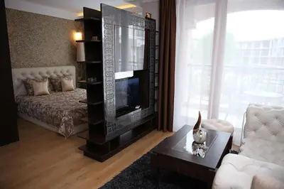 a living room with a tv and a couch at Harmony Palace in Sunny Beach