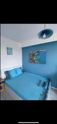 a blue bed with two pillows on top of it at Casa Del Mare in Chernomorets