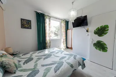a bedroom with a bed and a tv and a window at Casa Del Mare in Chernomorets