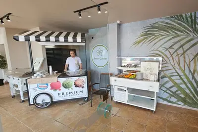 a man is standing behind a food cart at Sentido Bellevue Beach- All Inclusive & Beach Access in Sunny Beach