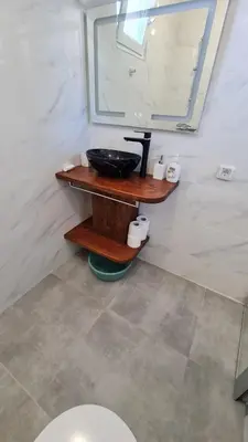 a bathroom with a sink and a mirror at S Apartment in Tsarevo