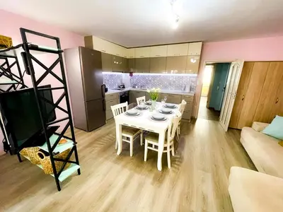 a living room with a table and a kitchen at Top Location !!FREE parking!! 