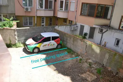 a car parked next to a wall with a tree parking space at Top Location !!FREE parking!! 