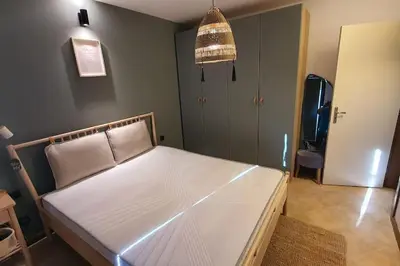 a bedroom with a large white bed in a room at Oasis Resort Apartment, Луксозен Апартамент в комплекс ОАЗИС in Lozenets
