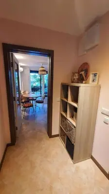 a hallway with a room with a dining room and a kitchen at Oasis Resort Apartment, Луксозен Апартамент в комплекс ОАЗИС in Lozenets