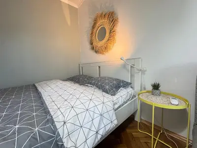 a bedroom with a bed and a mirror on the wall at LAZUR first line in Burgas City