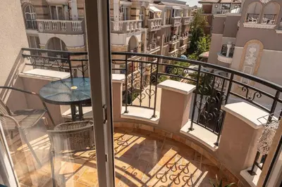 a view of a balcony with a table and a patio at Melia lux apartment in Ravda