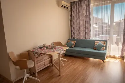 a living room with a couch and a table at Melia lux apartment in Ravda