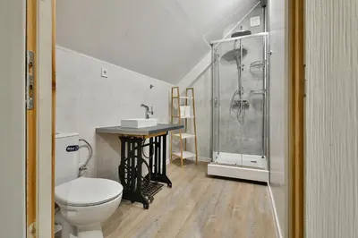 a bathroom with a shower and a toilet and a sink at Central Flats with parking in Varna City
