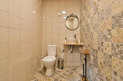 a bathroom with a toilet and a mirror at Central Flats with parking in Varna City