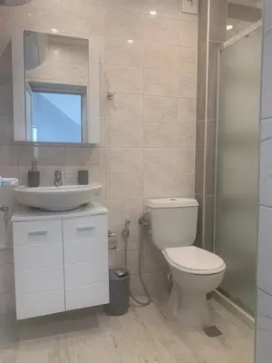 a bathroom with a toilet and a sink at Апартамент Енигма/Apart Enigma in Sveti Vlas