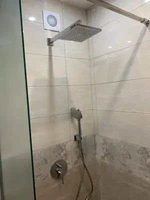 a shower with a shower head in a bathroom at Apartment Mihaela - 2 in Burgas City