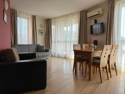 a living room with a table and a couch at PACIFIC-3-A in Sunny Beach