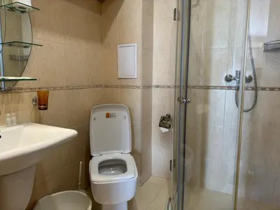 a bathroom with a toilet and a sink and a shower at PACIFIC-3-A in Sunny Beach