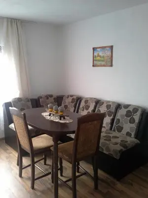 a living room with a table and a couch at Morski Rai Apartments in Byala