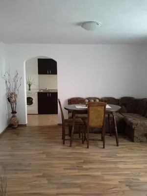 a living room with a table and chairs and a couch at Morski Rai Apartments in Byala