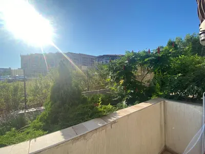 a view of a garden with the sun behind a fence at FREGATA 2 Studio Sveti Vlas in Sveti Vlas