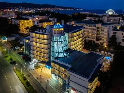 a night view of a building with a sign on it at Sol e Mar in Sunny Beach