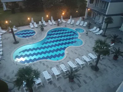 an overhead view of a swimming pool with chairs and tables at Sol e Mar in Sunny Beach