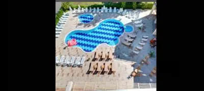 an aerial view of a large pool with chairs and tables at Sol e Mar in Sunny Beach