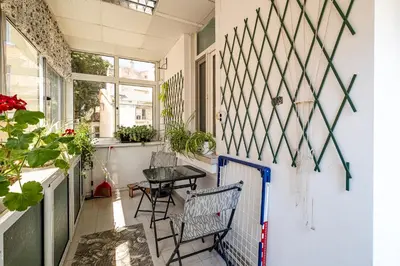 a small balcony with two chairs and a table at Aristocratic 2bdrm Central Apartment in Varna City