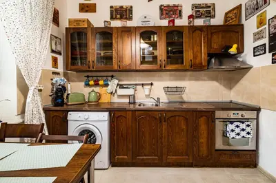 a kitchen with wooden cabinets and a dishwasher at Aristocratic 2bdrm Central Apartment in Varna City