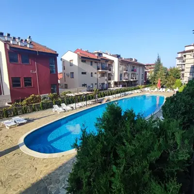 a swimming pool in the middle of some buildings at Panorama Bay 2 - Apartments by the beach in Sveti Vlas