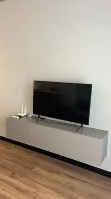 a flat screen tv sitting on a white entertainment center at Amber Home - brand NEW luxury 1 bedroom apartment located in the very city center in Varna City