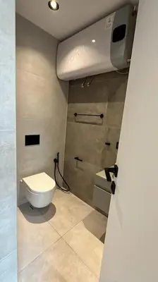 a small bathroom with a toilet and a sink at Amber Home - brand NEW luxury 1 bedroom apartment located in the very city center in Varna City