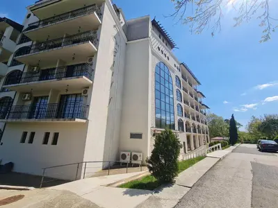 a building with a car parked in front of it at Apartment Almi - The Cliff Obzor in Obzor