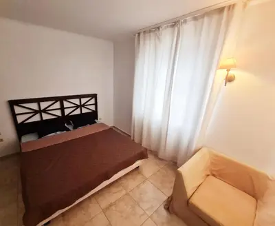 a small bedroom with a bed and a window at Apartment Almi - The Cliff Obzor in Obzor