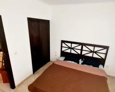 a bedroom with a bed with a black headboard at Apartment Almi - The Cliff Obzor in Obzor