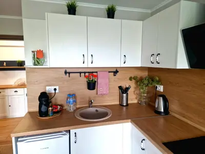 a kitchen with white cabinets and a sink at Луксозен Апартамент в Модерна сграда -Молимаркс Делукс Апартамент Бургас in Burgas City