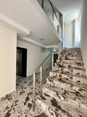 an empty staircase in a building with marble floors at Апартаменти Астрея Обзор - Apartments Astrea Obzor in Obzor