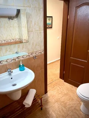 a bathroom with a sink and a toilet at Budget First Sea Line Apt. FLORA in Pomorie