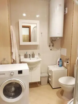a bathroom with a washing machine and a sink at Lovely bright studio on Sunny Beach in Sunny Beach
