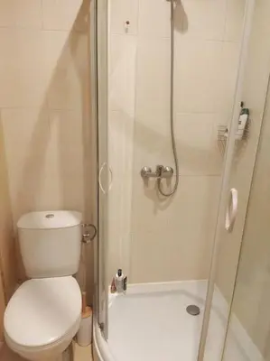 a small bathroom with a toilet and a shower at Lovely bright studio on Sunny Beach in Sunny Beach