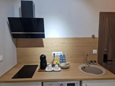 a bathroom counter with a sink and a tv on it at Дизайнерско Студио в Модерна сграда -Молимаркс Делукс Студио Бургас in Burgas City