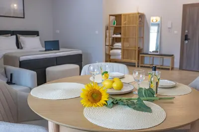 a wooden table with a sunflower on it in a living room at Дизайнерско Студио в Модерна сграда -Молимаркс Делукс Студио Бургас in Burgas City